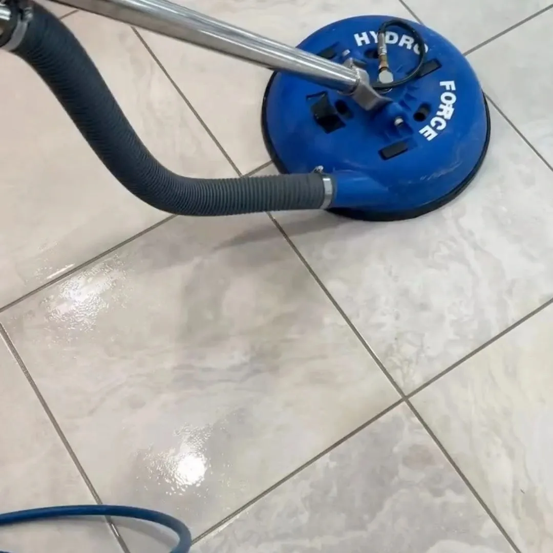 Hot water extraction tool deep cleaning tile and grout lines in a Saskatoon home
