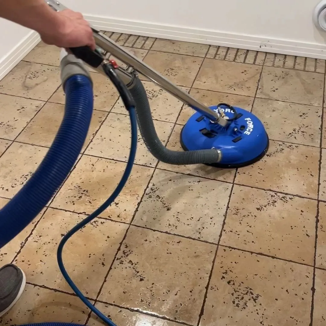 Tile and grout cleaning in Saskatoon showing dirty beige floor tile beside a freshly cleaned section