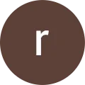 The letter r is in a brown circle on a white background.