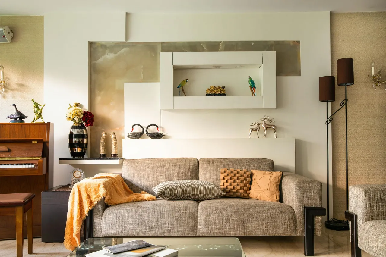 A living room with a couch and a piano